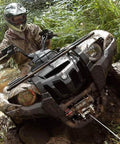 ATV equipped with Vantage 2000 12V DC Electric Winch for ATVs and UTVs with 2000 Lb Pull 55 Ft Steel Wire battling muddy terrain