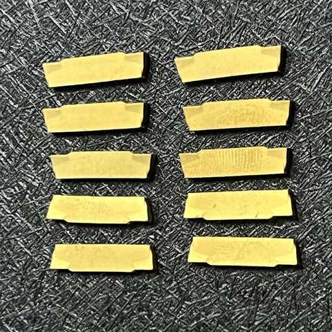10-Piece Pro Grade MGMN200-G Carbide Inserts for Internal Turning, laid out in two rows on a textured black surface.