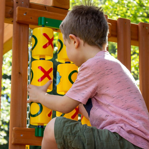Child playing with Tic Tac Toe Spinner Activity Panel For Swing Sets, Backyard Play Accessory, Durable UV Protected Plastic, Yellow