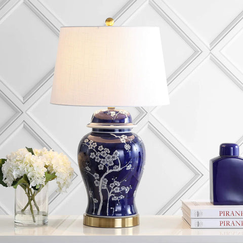 Traditional Ceramic Ginger Jar Table Lamp In White And Navy, Dope Chinoiserie Inspired Bedside Light With White Linen Shade, 29.5 Inch Tall, LED Bulb Included, ETL Listed For Safe Home Use displayed on a table with books and flowers.