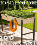 Planter box with hose in garden setting, not related to Owl Cast Iron Hose Holder For Wall Mount, Heavy Duty Garden Hose Hanger With Vintage Style.