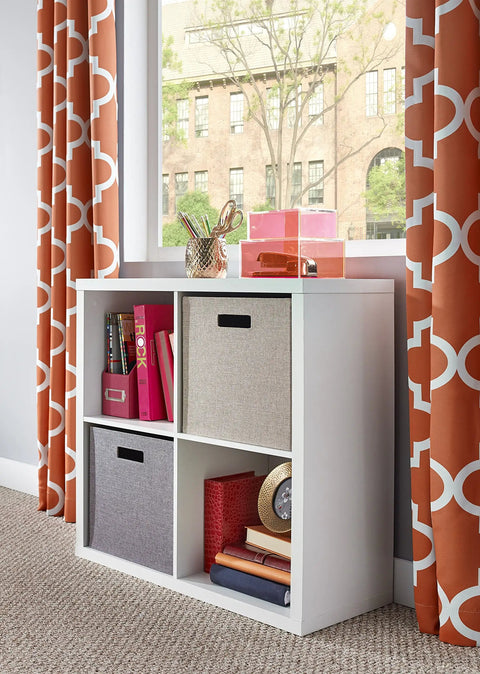 Four Cube Storage Shelf Organizer With Back Panel in home setting, featuring white wood finish, bins, and decor items by window.