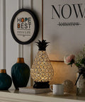 Extra Large Crystal Pineapple Lantern Lamp With IP44 Waterproof on a mantle, surrounded by decor items, battery operated.