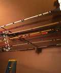 Easy Clip Garage Door Storage Rack With Hooks For Fishing Rods Kayak Paddles And Light Garden Tools Installs In Seconds No Tools Needed Clips To Garage Door Hinge Tubes For Quick No Fuss Organization showing multiple rods stored vertically on garage door.