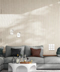 Modern living room with vertical panel wall and grey sofa, showcasing sleek design. No visible 12 Pack Self-Adhesive Acoustic Panels.