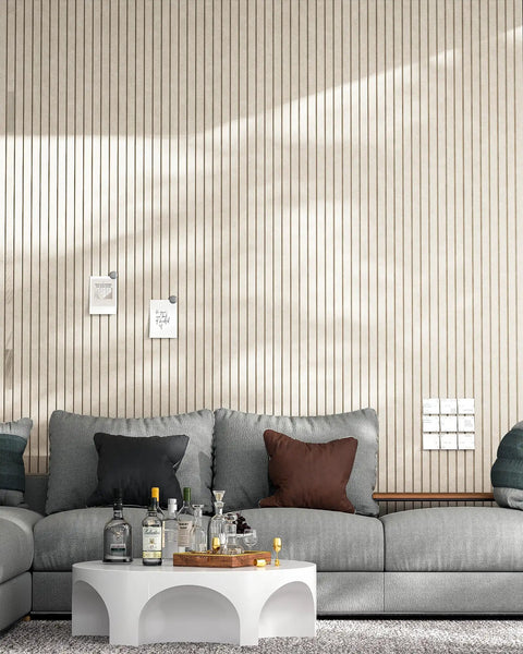 Modern living room with vertical panel wall and grey sofa, showcasing sleek design. No visible 12 Pack Self-Adhesive Acoustic Panels.