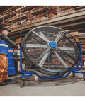 Six Foot Heavy Duty Mobile Industrial Barrel Fan Pumping Forty Thousand CFM Of Big Air Punch With Five Eighths HP ECM Motor in a warehouse.