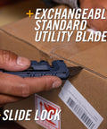 Blue Gerber Prybrid multi-tool close-up with pocket clip and exposed blade cutting cardboard.