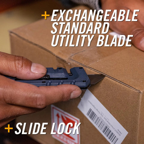 Blue Gerber Prybrid multi-tool close-up with pocket clip and exposed blade cutting cardboard.