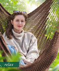Woman relaxing in an Extra Large Hammock Swing Chair With Spreader Bar For Indoor Or Outdoor Kick Back Relaxing, Handcrafted Rope Hanging Chair.