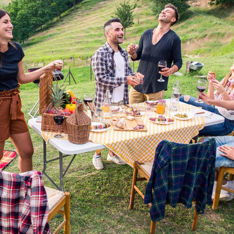 Group enjoying picnic with Six Foot Folding Table For Indoor And Outdoor Use, Portable Heavy Duty Fold In Half Plastic Dining Table With Carrying Handle