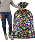 Person holding Giant 56 Inch Plastic Gift Bag with pink and yellow floral print, ideal for large gifts like ottomans and more.
