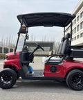 Top Shelf Two Seater Electric Golf Cart Equipped With A Dependable 48V Lithium Battery And Punchy Lightweight Frame For Sweet All Terrain Cruising In Fiery Red parked on asphalt.