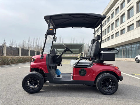 Top Shelf Two Seater Electric Golf Cart Equipped With A Dependable 48V Lithium Battery And Punchy Lightweight Frame For Sweet All Terrain Cruising In Fiery Red parked on asphalt.