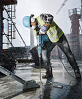Worker uses SDS Max Speed Xtreme Rotary Hammer Bit With 100 Percent Carbide Head Four Cutter Design for concrete drilling on site