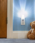 MLN 16 LED Plug In Night Light With Auto Dusk To Dawn Sensor And 5000K Daylight Illumination next to teddy bear in hallway