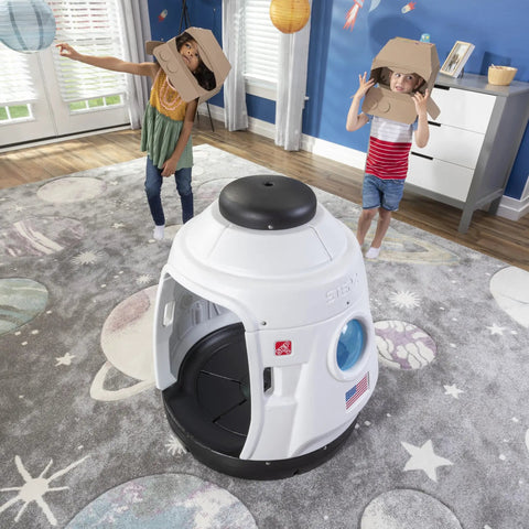 Children playing with Space Capsule Swing For Kids Indoor Outdoor Playhouse Two In One Backyard Playground Set Attaches To A Playset Or Tree Safe And Secure For Ages 3 To 8 Weather Resistant Rope Makes Park Quality Fun At Home in a living room.