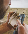 Craftsman using Flame Rotary Burr For Wood Carving Coarse Grade One Eighth Inch Shank Tungsten Carbide Bit on wooden piece.
