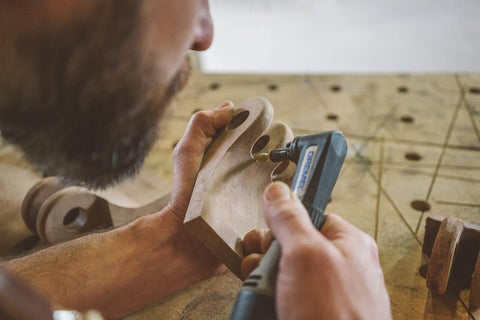 Craftsman using Flame Rotary Burr For Wood Carving Coarse Grade One Eighth Inch Shank Tungsten Carbide Bit on wooden piece.