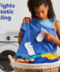 Woman holding blue shirt with Unscented Dryer Sheets 240 Count For Sensitive Skin Hypoallergenic Dermatologist Tested Wrinkle Reduction.