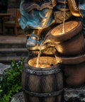 Close-up of 47-Inch Outdoor Water Fountain With 3-Tier Boy And Girl Resin Waterfall, focusing on LED lights and water flow in brown and blue.