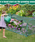 Child watering flowers inside Two Pack Raised Bed Garden Covers Pop Up Mesh Plant Covers For Outdoors 30 Percent Sunblock Shade Tent