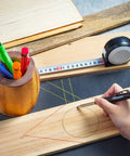 Using Mechanical Carpenter Pencil Set With Built In Sharpener And Long Nose Tip for precise scribing on wood with tape measure nearby.