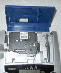 PTouch 2300 Labeling System No Fuss Stand Alone Label Maker With PC Compatibility shown open, displaying tape cartridge compartment.