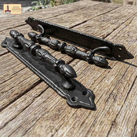 Heavy Duty Cast Iron Door Pull Handles Set Of 2 In Rustic Black With Colonial Victorian Style on wooden surface
