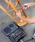 Person using Compact Home Tool Kit With Hammer Essential DIY Handy Hand Tool Set For Home Repairs In A Sturdy Case Includes Screwdrivers Pliers Tape Measure And Wrenches For Quick Everyday Fixes to fix a wooden stool.