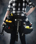 Worker with tool belt holding Heavy Duty Steel Hammer With Milled Face 22 Oz For Demolition Drywall And Wood One Piece Forged Steel I Beam Shaft For Extra Strength Magnetic Nail Set Front Of Head Nail Pull Made In USA.