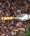 Heavy Duty 18 Gauge Stainless Steel Soil Scoop With Serrated Edge And Recycled Handle For Easy Soil Transfer, Root Cutting, And Clean, Tight Holes In Beds Or Planters, Silver on mulch