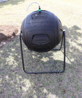 Ms Tumbles 35 Gallon Compost Tumbler With Easy Turn System on lawn, black and green, durable round design, outdoor composting setup