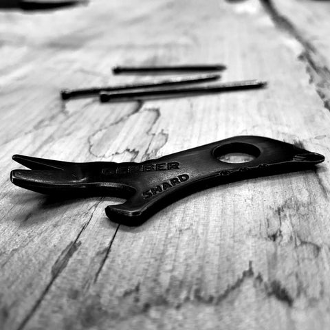 7 In 1 Keychain Multitool For Everyday Carry EDC Gear With Bottle Opener And Screwdrivers on wood surface