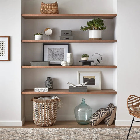 Decorative wood shelves with various home decor items and potted plants.
