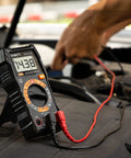 Digital Multimeter With Carrying Case For Home And Auto Use Tests DC And AC Voltage showing 14.38 volts on a car battery