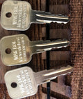 Gold Aluminum Pneumatic Ignition Keys Set 3 Pack For Heavy Equipment And Rollers Durable Aluminum Construction Powder Coated Finish Wacker Neuson Compatible displayed on wooden surface.