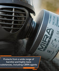 Close-up of a 40mm NATO NBC CBRN gas mask filter attached to a full face respirator, displaying vacuum-sealed packaging and branding.
