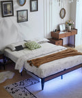 Modern Queen Platform Bed Frame Featuring Smart Rgb Led Lights And Usb Charging Station, with a cozy blanket and decorative pillows.