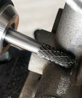 Close-up of YG6 Tungsten Carbide Rotary Burr Bit With One Quarter Inch Shank Double Cut Die Grinder Bit in use on metal