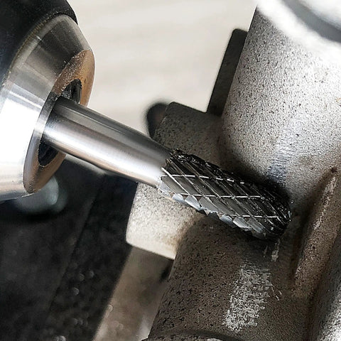 Close-up of YG6 Tungsten Carbide Rotary Burr Bit With One Quarter Inch Shank Double Cut Die Grinder Bit in use on metal