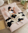 Woman napping on 66 Inch Oversized Plush Corduroy Chaise Lounge Chair No Assembly Sleeper Style Boneless Chair with blanket
