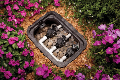 Replacement Solenoid For CP DV ASVF DAS JTV Series Valves Black installed in irrigation valve box surrounded by flowers.