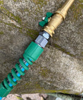 Close-up of the Heavy Duty Five Eighth Inch Garden Hose Fittings Kit Two Pack Metal Male Connectors with Bend Restrictor in use.