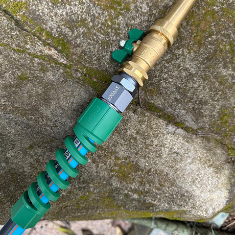 Close-up of the Heavy Duty Five Eighth Inch Garden Hose Fittings Kit Two Pack Metal Male Connectors with Bend Restrictor in use.
