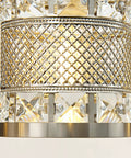 Close-up of crystal cylinder shade and brushed nickel detail on Over Mirror Four Bulb Bathroom Vanity Light With Cylinder Crystal Shade
