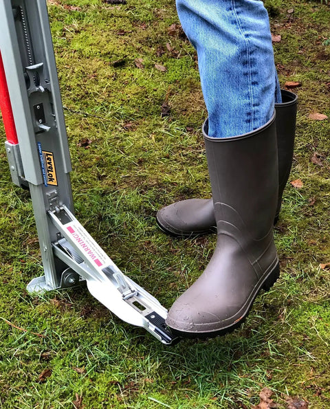Permanent Mount Heavy Duty Ladder Levelers Full Kit With Pro Grade Side Tip Stabilizer Arms For Two Ladders in use on grass