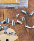 1/4-20 Threaded Wood Inserts Kit With 75 Pieces, hex drive nut inserts on wood surface, clear organizer box in background