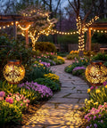 Two Pack Outdoor Solar Hanging Lantern Lights With Handle Waterproof Tabletop LED Moroccan Style Metal Garden Lanterns For Patio Lawn Porch Backyard Dope Lighting illuminating a garden pathway