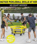 People playing Pickle 360 Outdoor Paddle Ball Game Set For Lawn Beach And Backyard No Court Needed 2 On 2 Family Friendly Fun